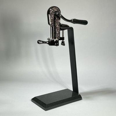 FRONTGATE TABLETOP WINE BOTTLE OPENER | Gunmetal assembly clamped to a powder-coated metal bracket with a cut stone base. - h. 23 x w....