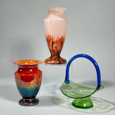 (3pc) ART GLASS VESSELS | Including two art glass vases with red and orange colors, and a blue and green glass handled basket. - h. 9.5...