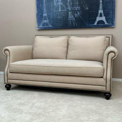BLOOMINGDALE’S TAN SOFA LOVESEAT | Clean tan fabric upholstery, deep seats with a fancy brass tack border. - h. 34 x w. 71 x d. 44 in

