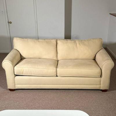 2 CUSHION SLEEPER SOFA | Cream 2 cushion sleeper sofa with pullout bed. - h. 28 x l. 74 x d. 37 in

