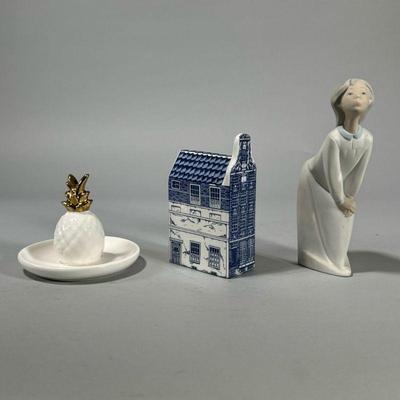 (3pc) DELFT & LLADRO | Including a Delft Holland Bel Gevel House (h. 5.5 in.), a Lladro figurine (h. 7 in.), and a pineapple form...