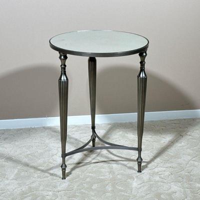 ROUND MIRRORED SIDE TABLE | End table with a mottled mirrored top over a silvered metal base with x-stretcher. - h. 22 x dia. 16 in

