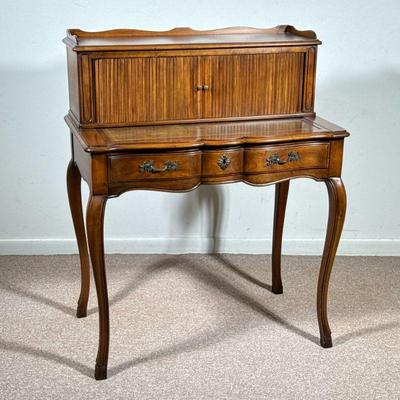 JOHN WIDDICOMB LADY'S WRITING DESK, OAK WITH ROLLER FRONT | The desk features a roller front with ribbed wood tambour door, which...