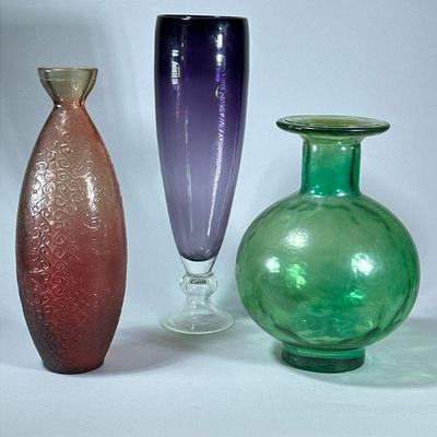 (3pc) LARGE COLORFUL VASES | Colorful art glass vases including a large purple vase, round green vase and tall orange/red vase with...