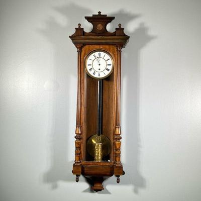 REGULATOR WALL CLOCK | White face with Roman numeral markers, with an engraved brass weight. - h. 45 x w. 15 x d. 6 in

