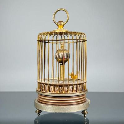 AUTOMATON CLOCK | Designed as a moving bird in a brass cage with a spherical revolving clock, no visible markings. - h. 4.5 x dia. 3 in

