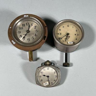 (3pc) MISC. CAR CLOCKS | Antique automobile clocks, including a Unique Recorder Co., Hazelton, PA clock, a Smiths clock, and a Westclox...