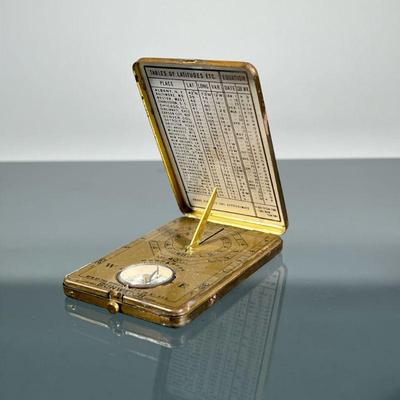 ANSONIA SUNWATCH | Manufactured by the Ansonia Clock Co., NY, pocket sundial and compass in a folding brass case. - w. 2 x l. 3 in

