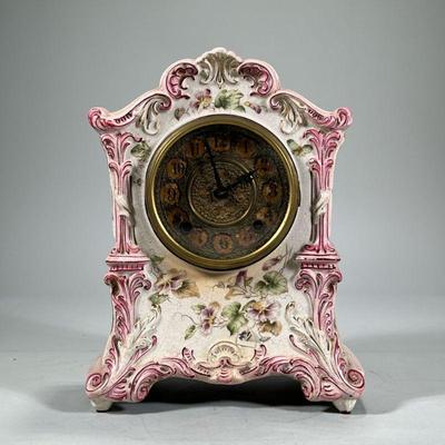 GILBERT PORCELAIN SHELF CLOCK | Pink glazed porcelain shelf clock with flower decoration from WML Gilbert Clock Co. No. 415. - h. 12 x w....
