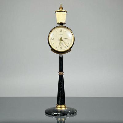 KAISER LAMP POST CLOCK | German, designed as a lamp post, having a silvered dial with abstract and Roman numeral markers, the face marked...