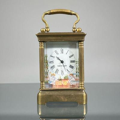 FRENCH PORCELAIN CARRIAGE CLOCK | Brass carriage clock of small size with five beveled glass panels and a painted porcelain face...