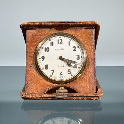 WALTHAM TRAVEL CLOCK | Waltham 8 day clock in a large pocket watch form set in a folding leather travel case, the watch having a brass...
