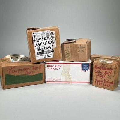 (6pc) MISC. CLOCK PARTS | Six small boxes of assorted clock parts, with boxes labeled "Waterbury Ship Bell Mvgt", "Hamburg...