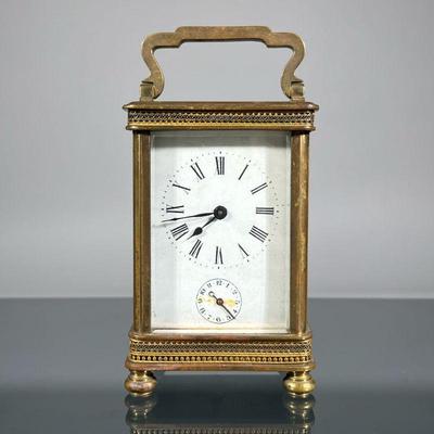 FRENCH BRASS CARRIAGE CLOCK | Brass case with beveled glass, face with Roman numeral markers and sub dial, marked "Made in...