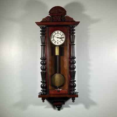 VIENNA REGULATOR WALL CLOCK | With ebonized half columns, enameled face with sub-second dial and black Roman numeral markers, with carved...