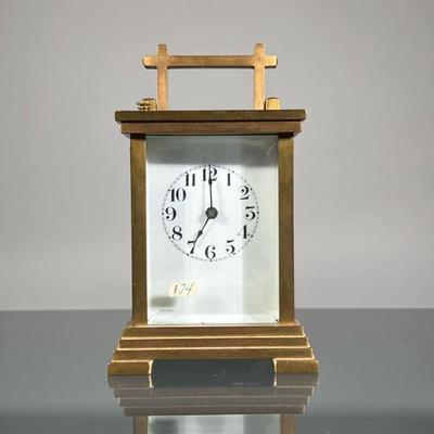 WATERBURY CARRIAGE CLOCK | A Waterbury Clock Co. Brass carriage clock with beveled glass panel, white face unsigned, with Arabic...