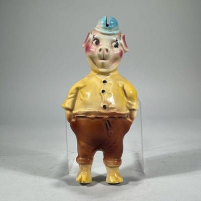 PIG-FORM PIGGY BANK | Glazed ceramic dressed pig-form piggy bank, mounts on the wall, marked on back "USA-661". - h. 12 x w. 3...