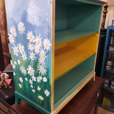 Fun painted shelf the other side has sunflowers 