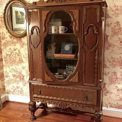 1930s wood cabinet with glass door.