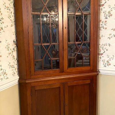 Corner cupboard with glass doors.