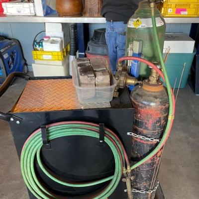 Welding tanks: Commercial size oxygen and acetylene tanks ready to use. Includes hoses, regulators, torch, and cart. 