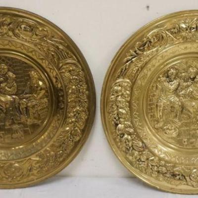 1251	PAIR OF LARGE BRASS EMBOSSED WALL CHAARGERS DEPICTING PUB SCENE, APPROXIMATELY 22 1/2 IN
