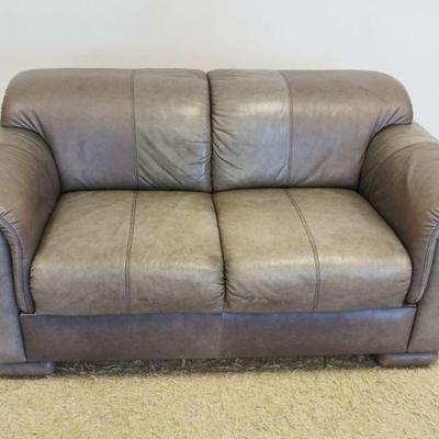 1107	GREY LEATHER LOVESEAT, SOME STAINING IN FRONT, APPROXIMATELY 39 IN X 63 IN X 29 IN HIGH
