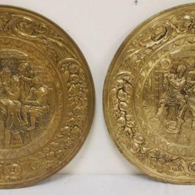 1250	PAIR OF LARGE BRASS EMBOSSED WALL CHAARGERS DEPICTING PUB SCENE, APPROXIMATELY 22 1/2 IN
