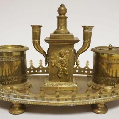 1067	ANTIQUE BRASS INKWELL W/EMBOSSED CHERUBS AT CENTER, MISSING GLASS INSERT, APPROXIMATELY 9 IN X 6 IN X 6 IN HIGH

