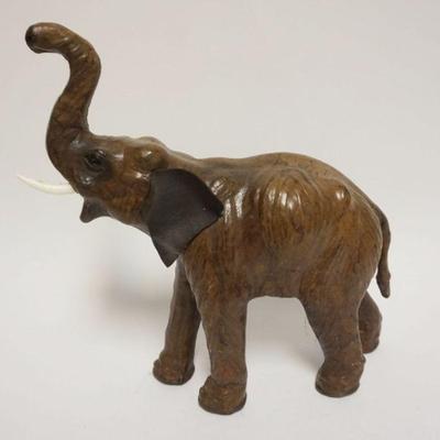 1039	LEATHER ELEPHANT MISSING ONE TUSK, APPROXIMATELY 14 IN X 6 IN X 14 IN HIGH
