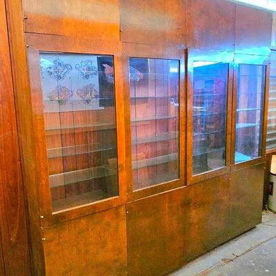 Large 4 section wood & glass display wall unit, with storage on the top & bottom.