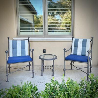 Four black metal outdoor chairs - two have solid blue upper cushions, and two have blue & white striped upper cushions. Three...