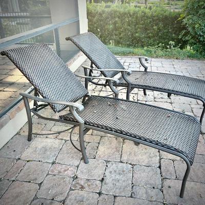 Pair of black metal chaise lounges