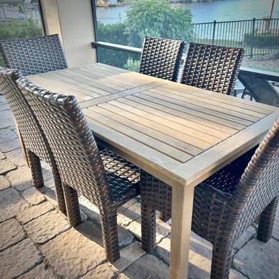 Teak dining table for 6, and six woven patio chairs