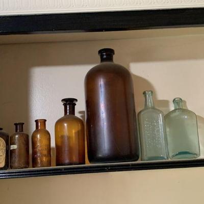 Lot 105 | Antique Glass Bottles On Shelf
