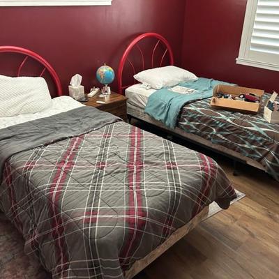 Twin beds, wooden night stand, blankets