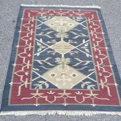 Rectangular blue and red area rug