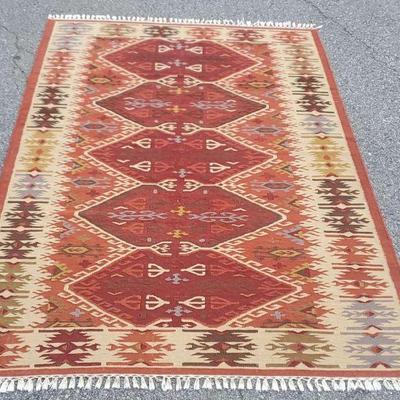 Large rich red and cream colored rug