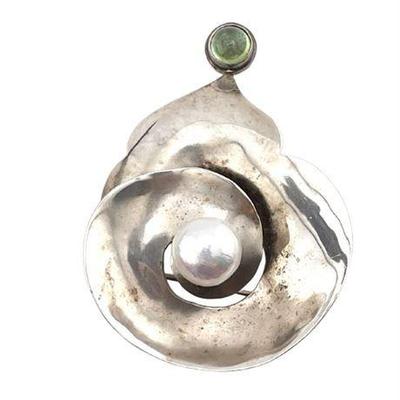 Lot 152   
Peridot Cabochon and 10 MM Cultured Pearl Set Sterling Silver Brooch