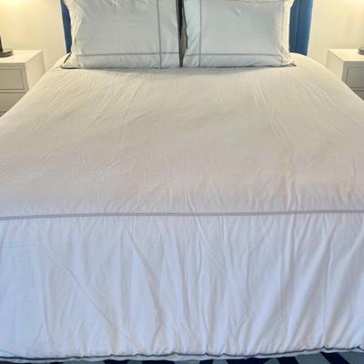 Bed with blue upholstered headboard