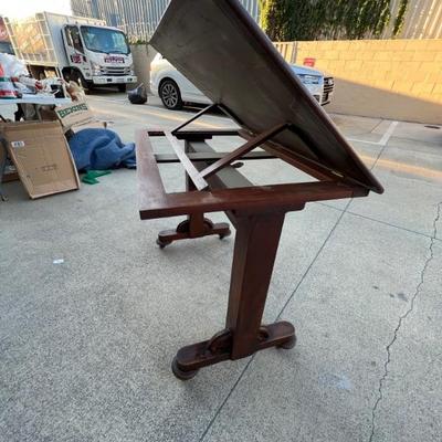 Drafting table very adjustable with leather inlay.