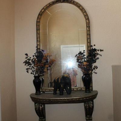 Asian Elephant on marble wall table with faux plant that needs sun