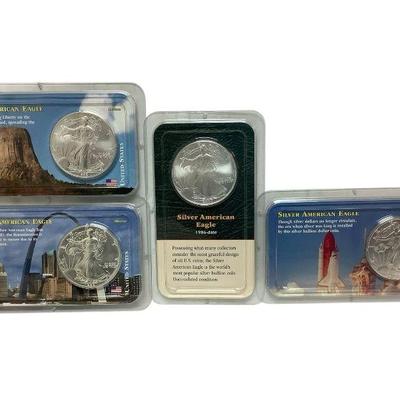 TN44 Four Silver Eagles	Four uncirculated American eagle silver dollars in their cases. Coins date to 1988, 1997, 1998, and 2000.
