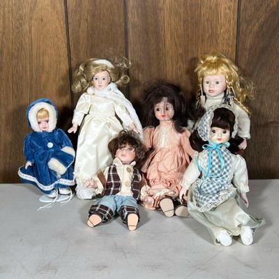(6pc) Small Porcelain Dolls | Including a collectible memory porcelain doll named Bailey, and others. - h. 13.5 in (largest)