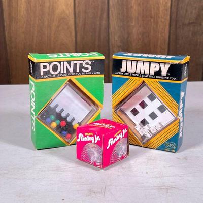(3pc) Vintage Toys | Including a Slinky Jr., a Jumpy puzzle, and a Points puzzle by Reiss. - h. 5.75 in

