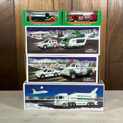 (5pc) [nib] Hess Trucks | Including a toy truck and race car, a space shuttle with satellite, a helicopter and rescue, firetruck, and...