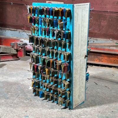 Curtis Industries Metal Key Rack | Filled with brass and anodized key blanks. - h. 26 x w. 14 x d. 12 in