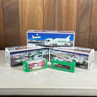 (5pc) Hess Trucks | Including a toy truck and race car, a space shuttle with satellite, a helicopter and rescue, firetruck, and miniature...