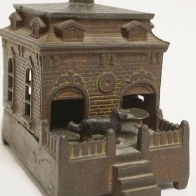 1054	ANTIQUE MECHANICAL CAST IRON BANK, DOG ON TURNTABLE ACTIVATED BY CRANK, APPROXIMATELY 6 IN X 4 IN X 5 1/2 IN H
