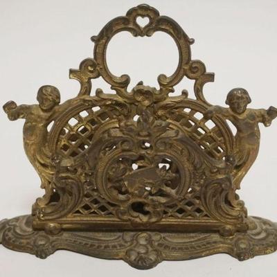 1050	ANTIQUE BRASS BRADLEY & HUBBARD LETTER HOLDER. HAVING 3 SECTIONS FLANKED BY IMAGES OF CHERUBS, APPROXIMATELY 9 IN X 4 IN X 6 1/2...